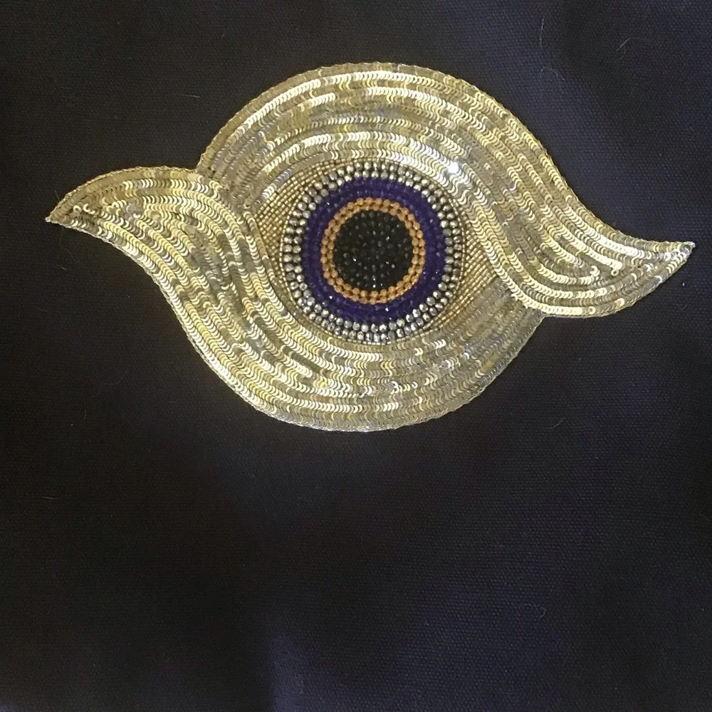 Figue navy blue clutch with sequined evil eye and Pom poms